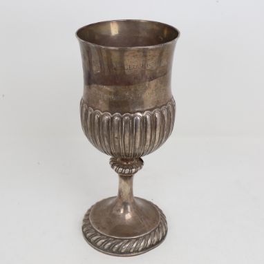 A George III Irish silver trophy cup, half fluted thistle form with gadrooned foot and presentation engraving, possibly by Th