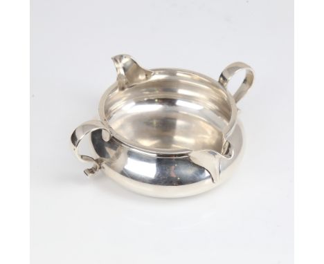 A late Victorian silver double-spout cream jug, circular squat form, by John Henry Rawlings, hallmarks London 1898, diameter 