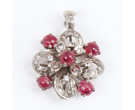 A Vintage unmarked white metal ruby and diamond flowerhead pendant, set with cabochon ruby and eight-cut diamonds, pendant he