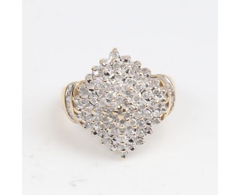 A modern 9ct gold diamond cluster cocktail ring, set with round brilliant and tapered baguette-cut diamonds, total diamond co