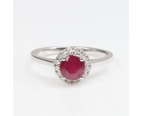A modern 14ct white gold ruby and diamond cluster ring, set with round-cut ruby and round brilliant-cut diamonds, total diamo
