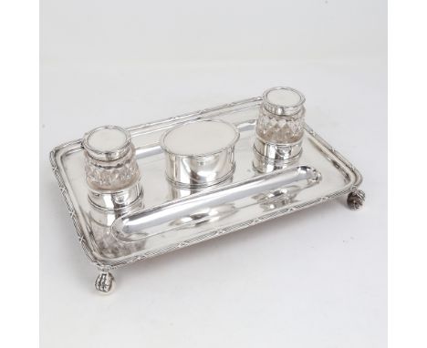 A George V silver deskstand, rectangular form with pen trays, 2 silver-mounted glass inkwells and stamp box on ball and claw 