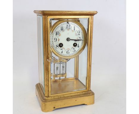 An early 20th century French brass-cased 4-glass 8-day mantel clock, floral white enamel dial with Arabic numerals and moveme