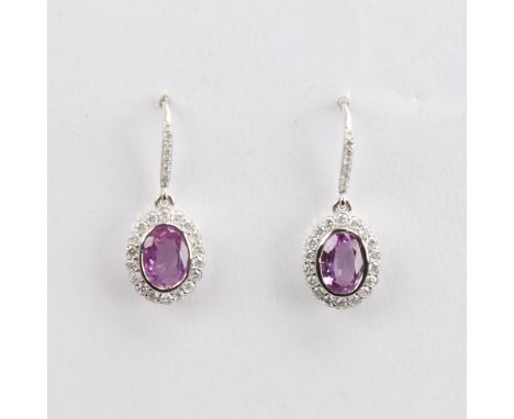 A modern pair of 14ct white gold pink sapphire and diamond cluster earrings, set with oval mixed-cut sapphires, round brillia