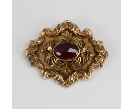 A Victorian unmarked gold cabochon garnet brooch, relief foliate border with textured ground and floral decoration, brooch le