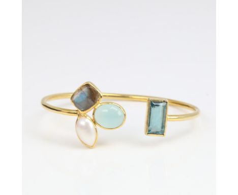 A modern unmarked silver-gilt gem set torque bangle/bracelet, gemstones include fluorite, labradorite, moonstone and pearl, i