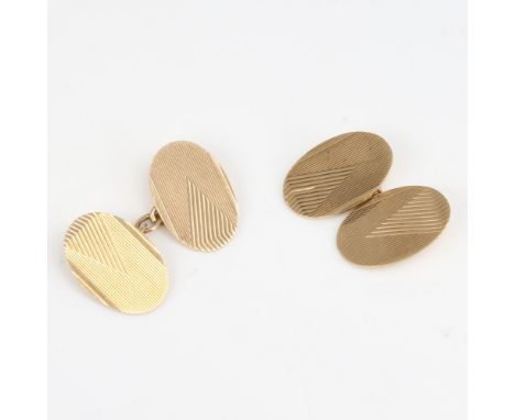 A pair of 9ct gold cufflinks, oval panels with engine turned decoration, maker's marks S and P, hallmarks Birmingham 1920, pa