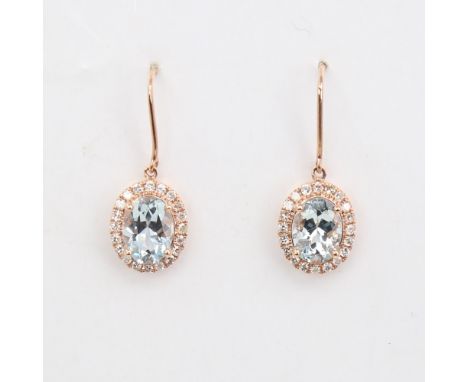 A modern pair of 14ct rose gold aquamarine and diamond cluster pendant earrings, set with oval-cut aquamarine and round-cut d