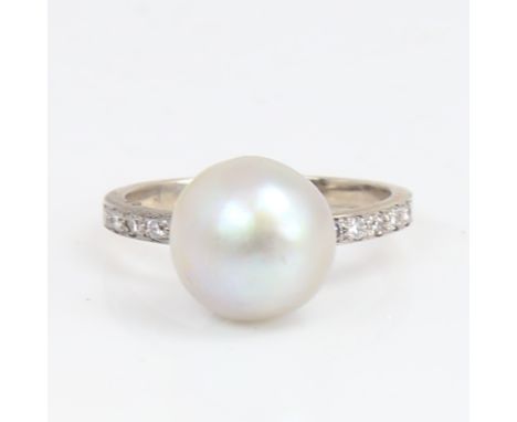 A 14ct white gold whole pearl and diamond ring, shoulders set with round brilliant-cut diamonds, pearl diameter 11.2mm, size 