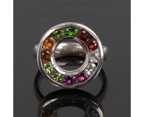 A modern handmade unmarked silver gem set halo ring, setting height 19.2mm, size P, 6.7gNo damage or repair, all stones prese