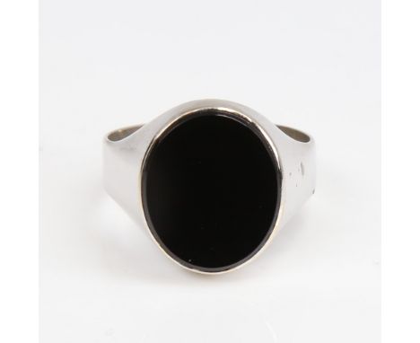A large unmarked white gold onyx signet ring, setting height 17.5mm, size W, 5.9gNo damage or repair, settings lightly abrade