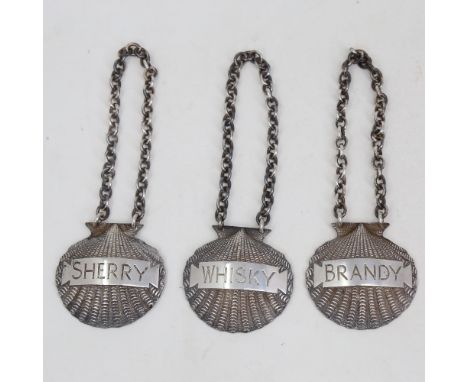 A set of 3 Elizabeth II cast-silver shell spirit decanter labels, comprising Whisky, Brandy and Sherry, by J B Chatterley & S