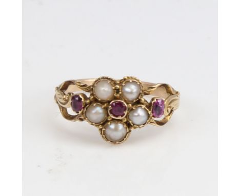 A Victorian unmarked gold split-pearl and ruby cluster memorial ring, central flowerhead design with pierced and engraved fol