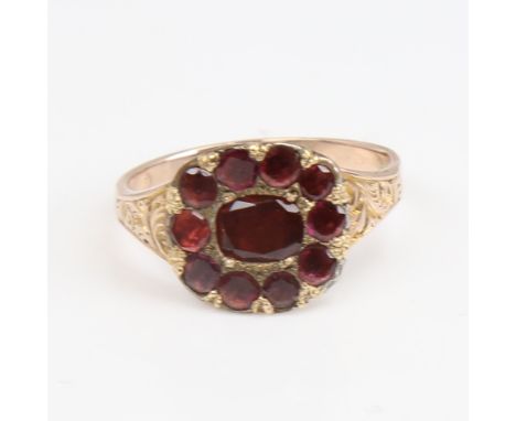 A Georgian unmarked gold flat-top garnet ring, foliate engraved shoulders with closed backs, setting height 12mm, size O/P, 2