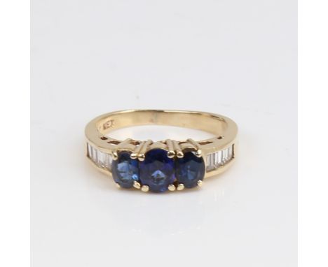 A modern 14ct gold sapphire and diamond dress ring, set with oval mixed-cut sapphires and baguette-cut diamonds, total diamon