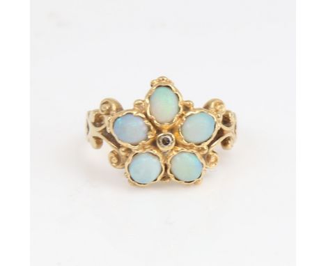 An 18ct gold cabochon opal and diamond cluster flowerhead ring, pierced and engraved scrollwork shoulders, maker's marks LAQ,