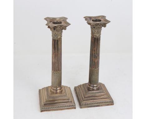 A pair of George V silver Corinthian column table candlesticks, stepped bases with removeable sconces, by Hawksworth, Eyre & 