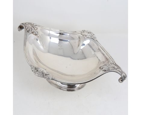 A large George V silver 2-handled table centre fruit bowl, oval form with cast scrolled acanthus leaf handles, by Atkins Brot