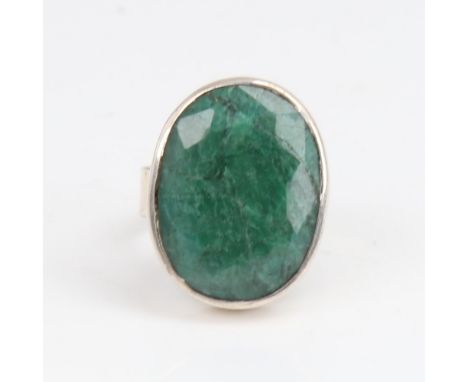 A modern sterling silver emerald ring, set with large oval mixed-cut emerald, setting height 24.3mm, size P, 10gNo damage or 