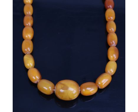 A long graduate single-row butterscotch amber bead necklace, beads measuring from 27.8mm to 13.4mm, necklace length 68cm, 67.
