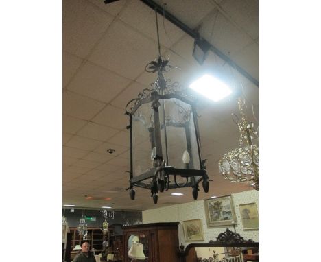 A METAL THREE LIGHT HALL LANTERN of octagonal form with C scroll and stylized flowerhead decoration
The buyer of this lot wil