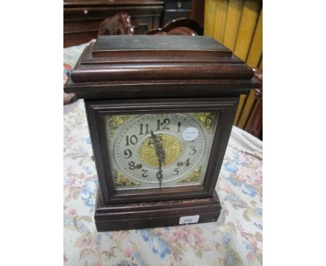 A STAINED BEECHWOOD MANTLE CLOCK of rectangular form the silvered and brass dial raised on a stepped base 34cm (h) x 24cm (w)