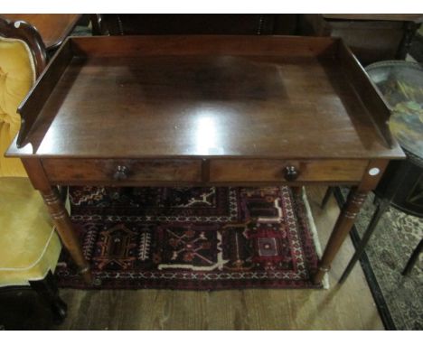 A VICTORIAN MAHOGANY SIDE TABLE the rectangular top with moulded gallery and two frieze drawers on turned legs