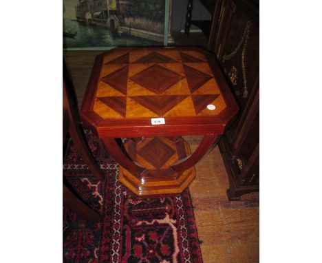 AN ART DECO STYLE OCCASIONAL TABLE the rectangular top with canted angles raised on a curved support and stepped platform bas