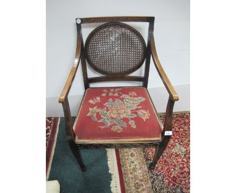 A MAHOGANY ARMCHAIR with Greek key carved top rail above an oval bergere panel and needlework seat on square tapering legs