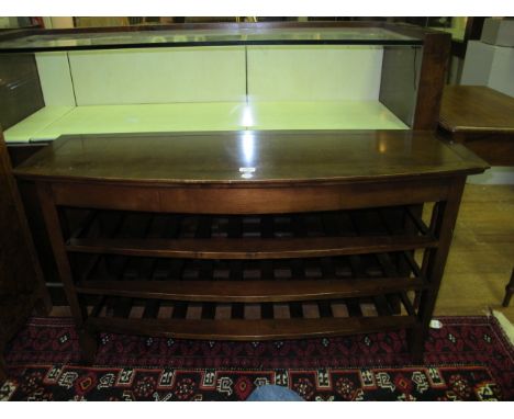 A CHERRYWOOD THREE TIER SHELF of demi-lune outline the shaped moulded top above three slatted shelves on moulded legs 71cm (h