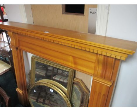 A PINE FIRE SURROUND the rectangular shelf with dentil moulded frieze raised on moulded jabs with scroll capital 124cm (h) x 