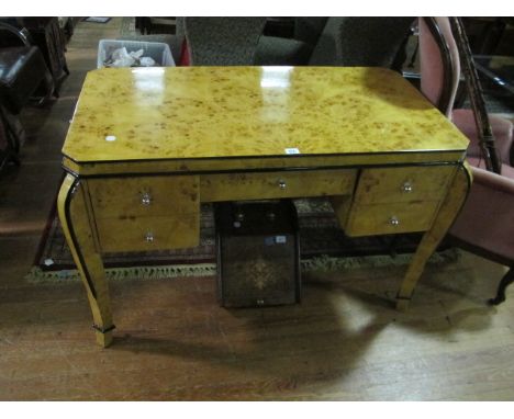 AN ART DECO STYLE WALNUT DESK the rectangular top with canted angles and five frieze drawers on moulded legs