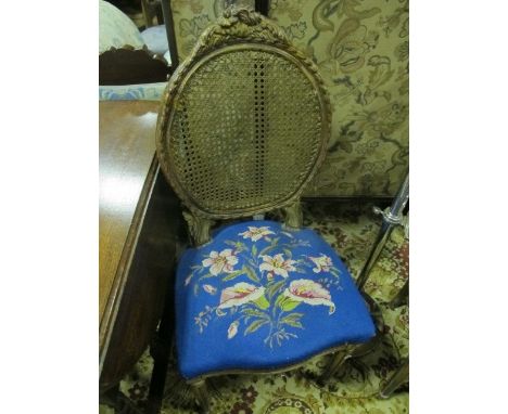 A PAIR OF CONTINENTAL GILTWOOD SIDE CHAIRS each with a foliate and flowerhead cresting above an oval bergere panel with needl