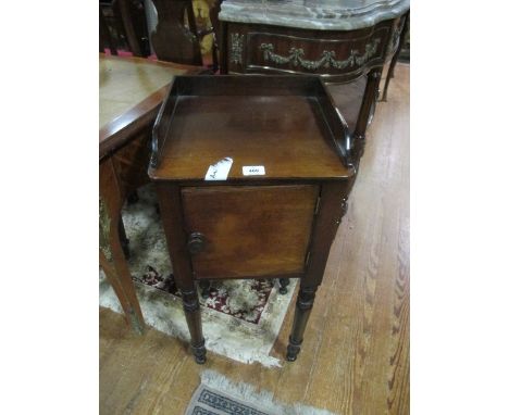 A VICTORIAN MAHOGANY POT CUPBOARD the rectangular top with moulded three quarter gallery above a panel door on turned legs 86