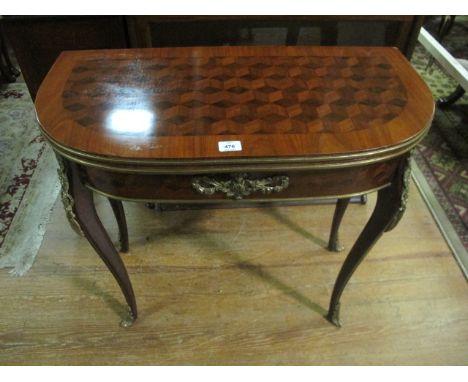 A CONTINENTAL KINGWOOD AND GILT BRASS MOUNTED CARD TABLE of demi-lune outline the shaped hinged top containing a tooled leath