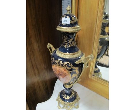 A FINE PAIR OF CONTINENTAL PORCELAIN AND GILT BRASS LIDDED VASES each of urn form the blue and gilt ground decorated with flo