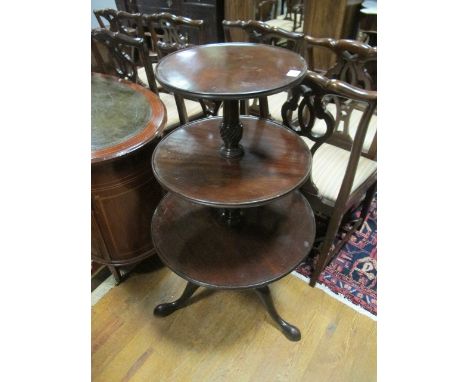 A GEORGIAN MAHOGANY THREE TIER DUMB WAITER each circular dish raised on a spiral twist column and tripod support with pad fee