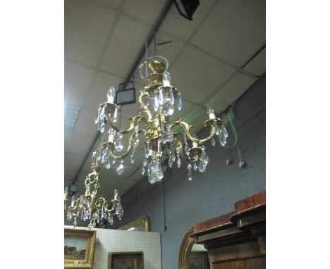 A CONTINENTAL GILT BRASS FIVE BRANCH CHANDELIER the leaf cast scroll arms hung with pendant drops
The buyer of this lot will 