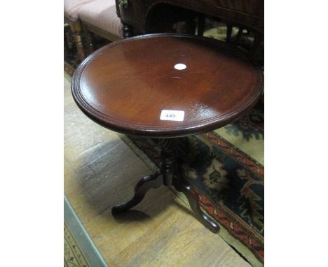 A MAHOGANY WINE TABLE the circular dish top above a baluster column on tripod support 55cm (h) x 42cm (d)