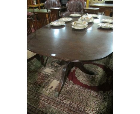 A GEORGIAN STYLE MAHOGANY D-END DINING TABLE the rectangular top with rounded ends and one loose leaf raised on twin tripod s