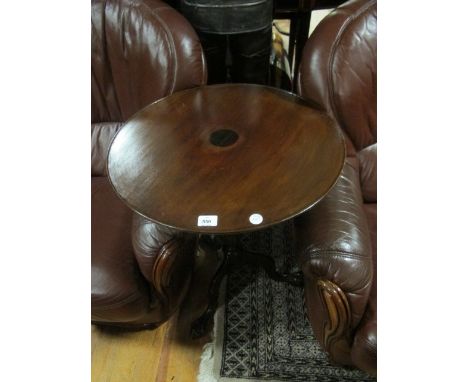 A GEORGIAN MAHOGANY OCCASIONAL TABLE the oval dish top raised on a baluster and ring turned column on tripod support with bal