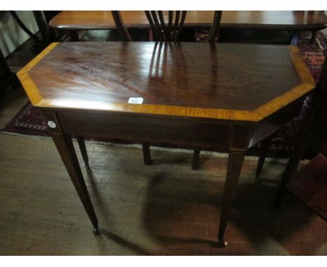 AN EDWARDIAN MAHOGANY AND SATINWOOD CROSS BANDED SIDE TABLE the rectangular top with canted angles on square tapering legs wi