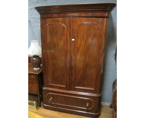 A VICTORIAN MAHOGANY WARDROBE the outset moulded cornice above a pair of rectangular arched panel doors containing hanging ra