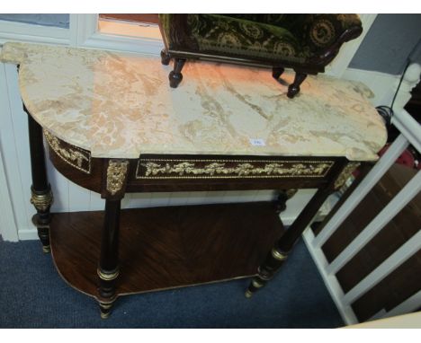 A CONTINENTAL MAHOGANY AND GILT BRASS MOUNTED SIDE TABLE surmounted with a sienna marble top of inverted breakfront bowed out