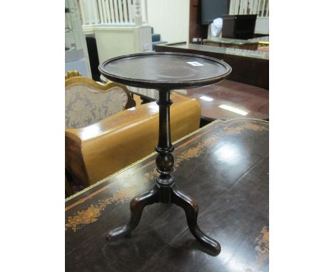 A MAHOGANY WINE TABLE the circular dish top above a baluster column on tripod support 47cm (h) x 26cm (d)