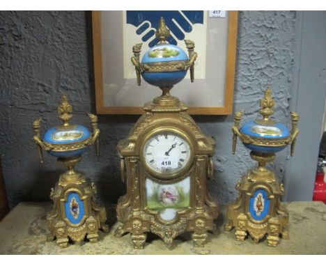 A FRENCH GILT BRASS AND PORCELAIN CLOCK GARNITURE 19th Century the rectangular arched case with enamel dial surmounted with a