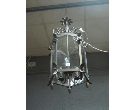 A METAL THREE LIGHT HALL LANTERN of octagonal form with C scroll and stylized flowerhead decoration