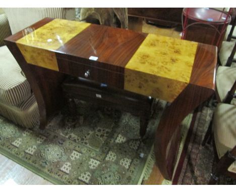 AN ART DECO STYLE WALNUT AND ROSEWOOD SIDE TABLE the rectangular top with frieze drawer and curved standard end supports 84cm