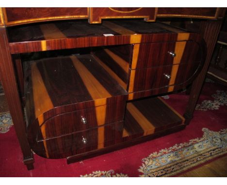 AN ART DECO STYLE ROSEWOOD AND WALNUT TABLE the rectangular bowed top containing two frieze drawers with open compartments th