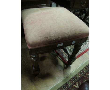 A CONTINENTAL WALNUT STOOL the square upholstered seat above a panel frieze and reeded tapering legs joined by a baluster str